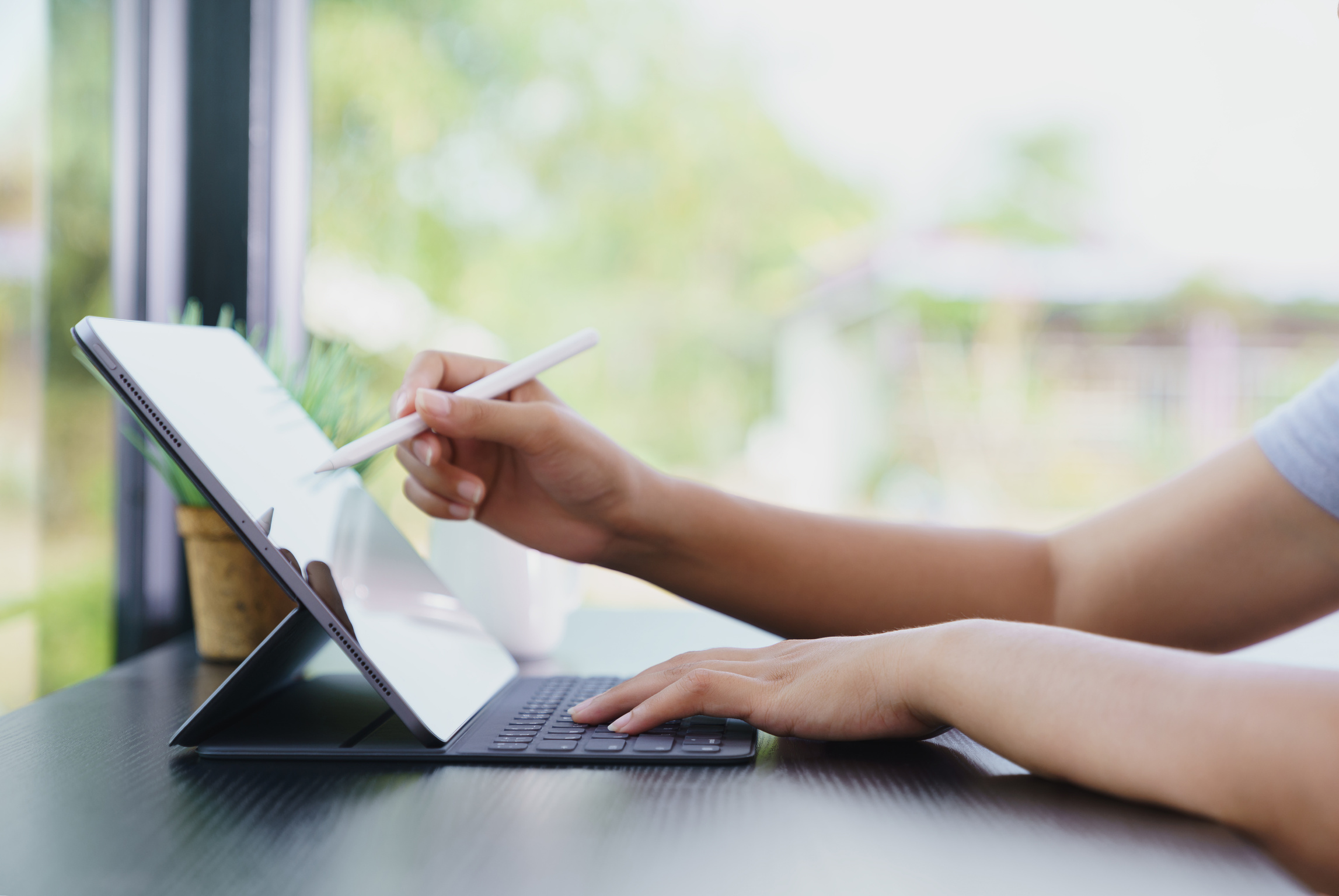 Person Using Digital Tablet with Stylus Pen